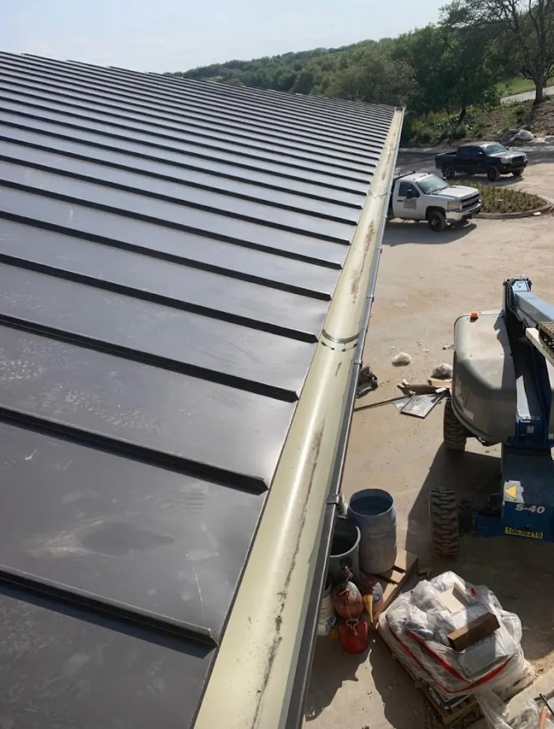 Standing seam panel and gutter detail on a metal roofing jobsite in Foster City